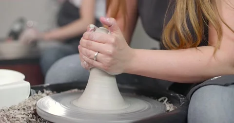 Close-up of the hand of a master potter working on a potter's wheel, forming a Stock Footage 156525060