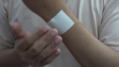 Close-Up of Hand with Medicated Patch on Wrist Video stock 301943550