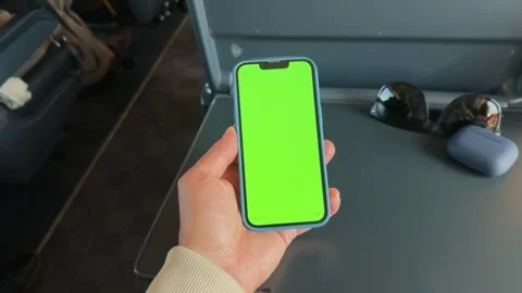 Close-up of a hand with a mobile phone with a green screen in a train carriage Stock Footage 280568108
