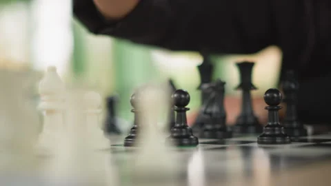 Close up of hand moving chess pawns on checkered board with focus and natural Stock-Footage 346649752