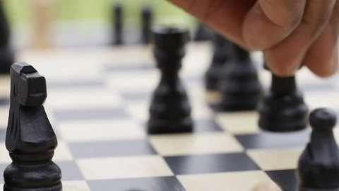 Close up of hand moving a chess piece to win a checkmate Vidéo 77088601
