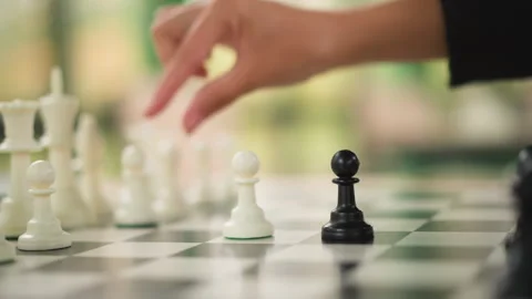 Close up of hand moving chess pieces on board with soft lighting and shallow Stock-Footage 346649713