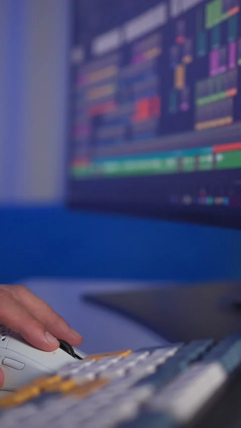 Close-up hand moving computer mouse during audio mixing on illuminated monitor Stock Footage 347869378