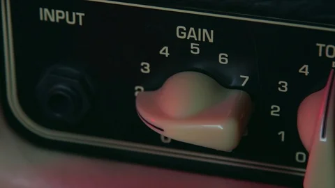 Close up of Hand Moving Gain Button up of Amplifier Stock Footage 124086441