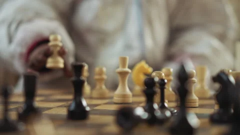 Close Up of Hand Moving White Chess Piece During Indoor Game Stock-Footage 347075453
