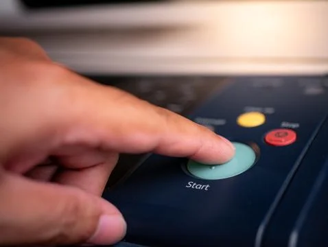 Close up hand office man press start button on panel to using the Office pr.. Stock Photos