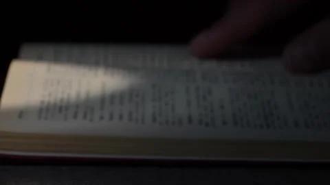 Close-up of a hand on an old book, an old man's finger runs along the lines of Video stock 252272369