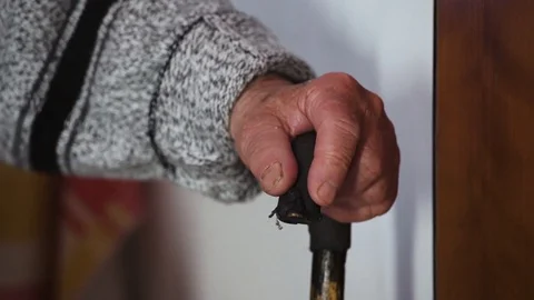 Close up on Hand of old man clutching the stick Stock Footage