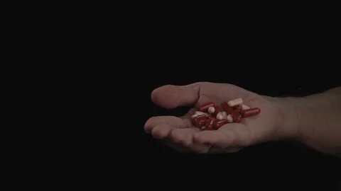 Close up. Hand of old man holding a pill on black background Concept illness Video stock 105922687