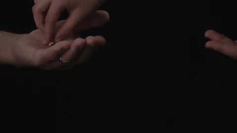 Close up. Hand of old man holding a pill on black background Concept illness Stock Footage 105927816