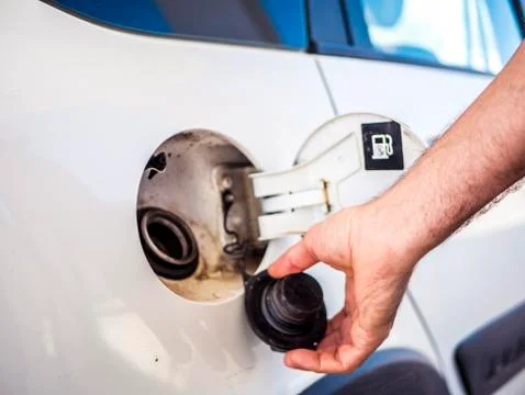 Close up hand open and close gas tank cap white car to fill it with fuel Stock Photos