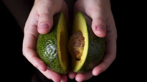 Close up hand open avocado fruit Stock Footage 127419777