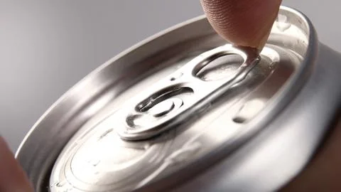 Close up of hand open cola or soda beverage can with pull tab. Stock Photos
