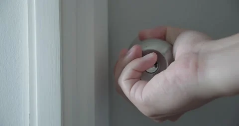 Close up of hand open the door knobs of white door. Man hand open door knob. Video stock 156440819