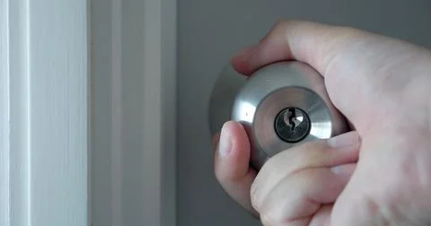 Close up of hand open the door knobs of white door. Man hand open door knob Stock Photos
