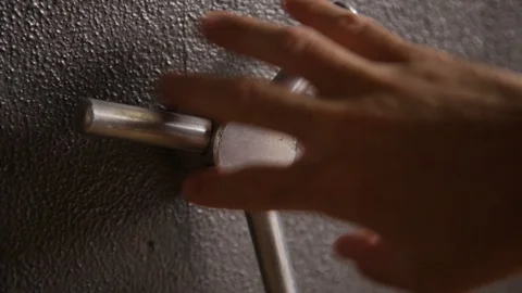 Close up - Hand opening and closing a safe with handle Stock Footage 86895771