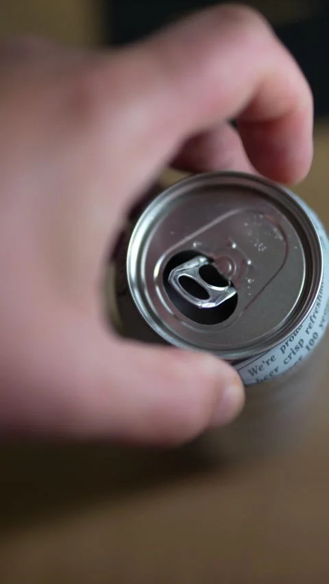 Close-up of hand opening beer can, top view, soft lighting Stock Footage 332863401
