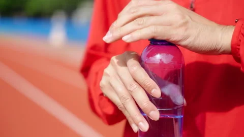 Close up hand opening the bottle cap after running. Video stock 248121904