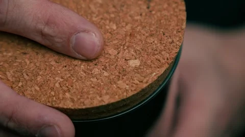 Close-up of a hand opening the cork lid of a jar Stock Footage 328442359