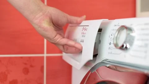 Close-up of hand opening detergent drawer of washing machine, preparing for Stock Footage 290831810