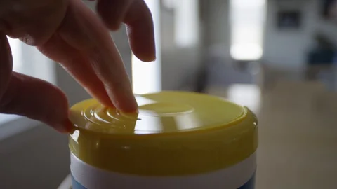 Close up of hand opening lid and pulling out wet wipe Video stock 128918935