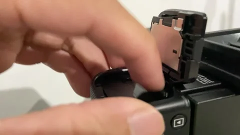 Close up Hand Opening Memory Card Slot on Digital Camera Stock Footage 314197964