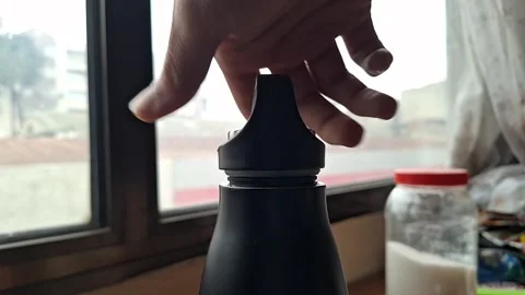 Close-Up of Hand Opening Reusable Water Bottle Stock Footage 329748969