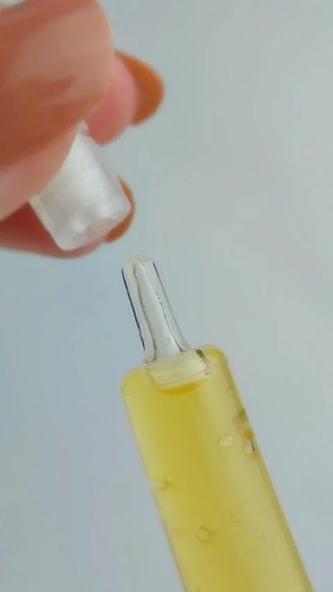 Close up of hand opening serum cap, golden yellow beauty skincare product w.. Vídeos de archivo 331231525