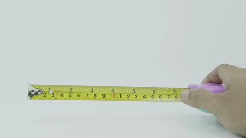 Close Up Hand Opening Tape Measure  on White Background Stock Footage 292041544