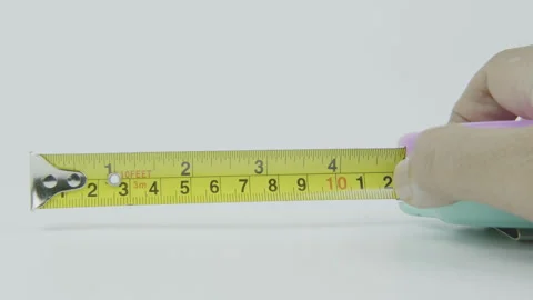 Close Up Hand Opening Tape Measure for Measurement Concept Stock Footage 292042374