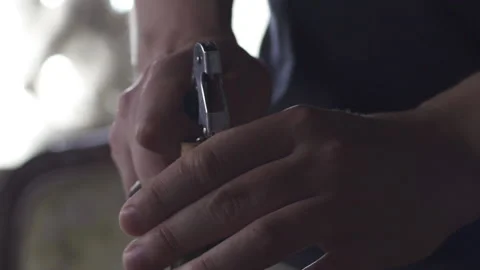 Close-up hand opening the wine bottle using the corkscrew. Slow motion 50 fps. Stock Footage 153383914
