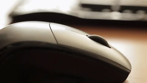 Close-up of a hand operating a computer mouse on a wooden desk Stock Footage 278144489