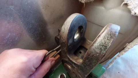 Close up of hand operating heavy duty hitch pin on agricultural machinery Vídeo Stock 334396558