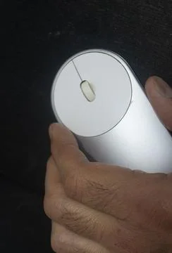 Close-up of a hand operating a modern ergonomic computer mouse Stock Photos