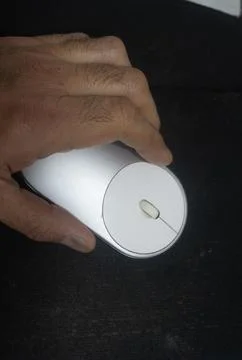 Close-up of a hand operating a modern ergonomic computer mouse Stock Photos