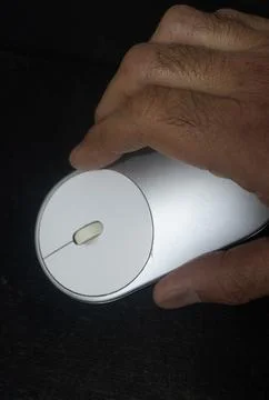 Close-up of a hand operating a modern ergonomic computer mouse Stock Photos