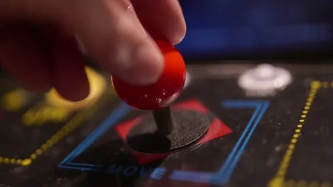 Close up of a hand operating a red joystick Stock Footage 346644215