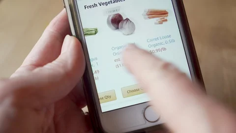 Close up of a hand order fresh vegetables from their mobile phone app Stock Footage 127983715