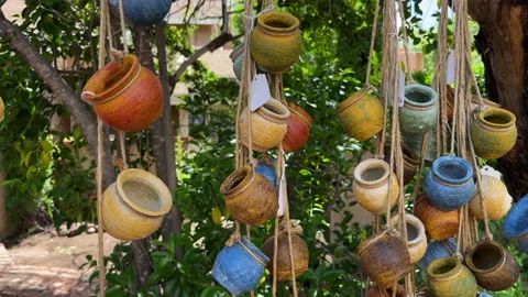 Close-up of hand-painted assorted small jars on display hanging on strings Stock Footage 167193065