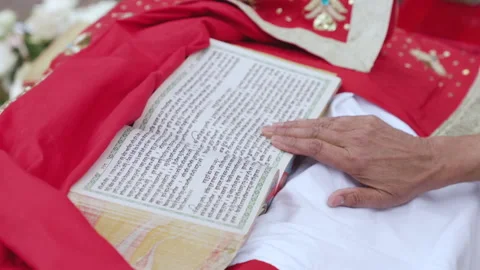 Close-up of hand passes over the text of holy Indian religious book Video stock 220047949
