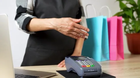 Close-up of hand paying pos terminal with phone Stock Footage 254339506