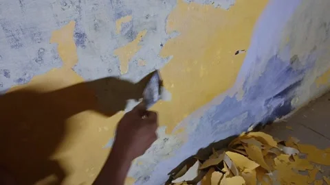 Close Up Of Hand Peeling A Paint On An Old House Wall Video stock 169033847