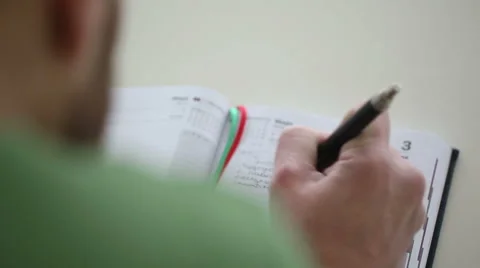 Close up of hand pen writes in a notebook Stock Footage 47745634