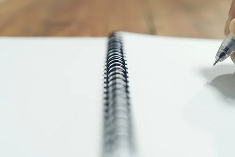 Close up hand of with pen writing on notebook Stock Photos