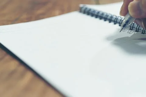 Close up hand of with pen writing on notebook Stock Photos