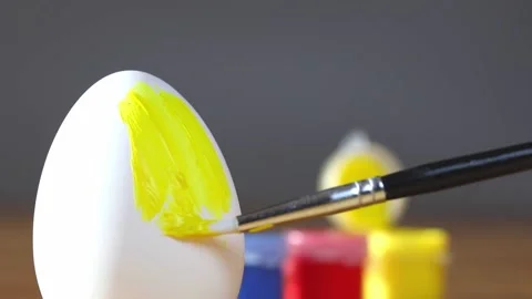Close up hand people painting easter eggs. child colouring eggs, preparing for Stock Footage 232489888