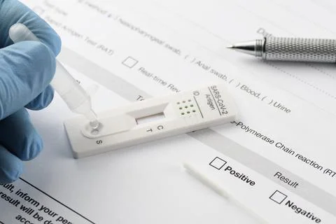 Close-up of hand performing a rapid antigen test for SARS-CoV-2, COVID-19 Stock Photos