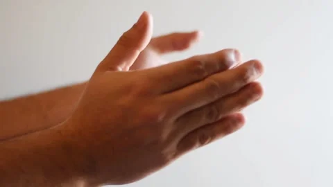 Close up hand of a person clapping with white background and natural light Stock Footage 236595611