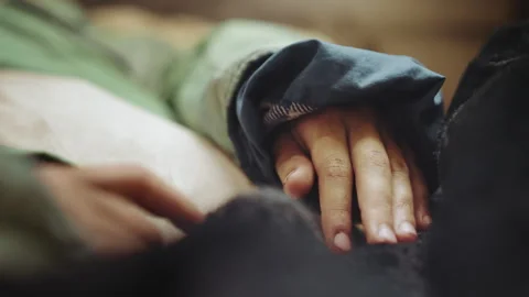 Close Up Hand Of Person Lying Down In Worn Jacket 動画素材 347076628