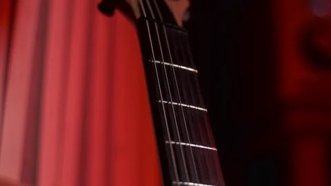 Close Up of Hand Pick Up the Guitar Stock Footage 123857597